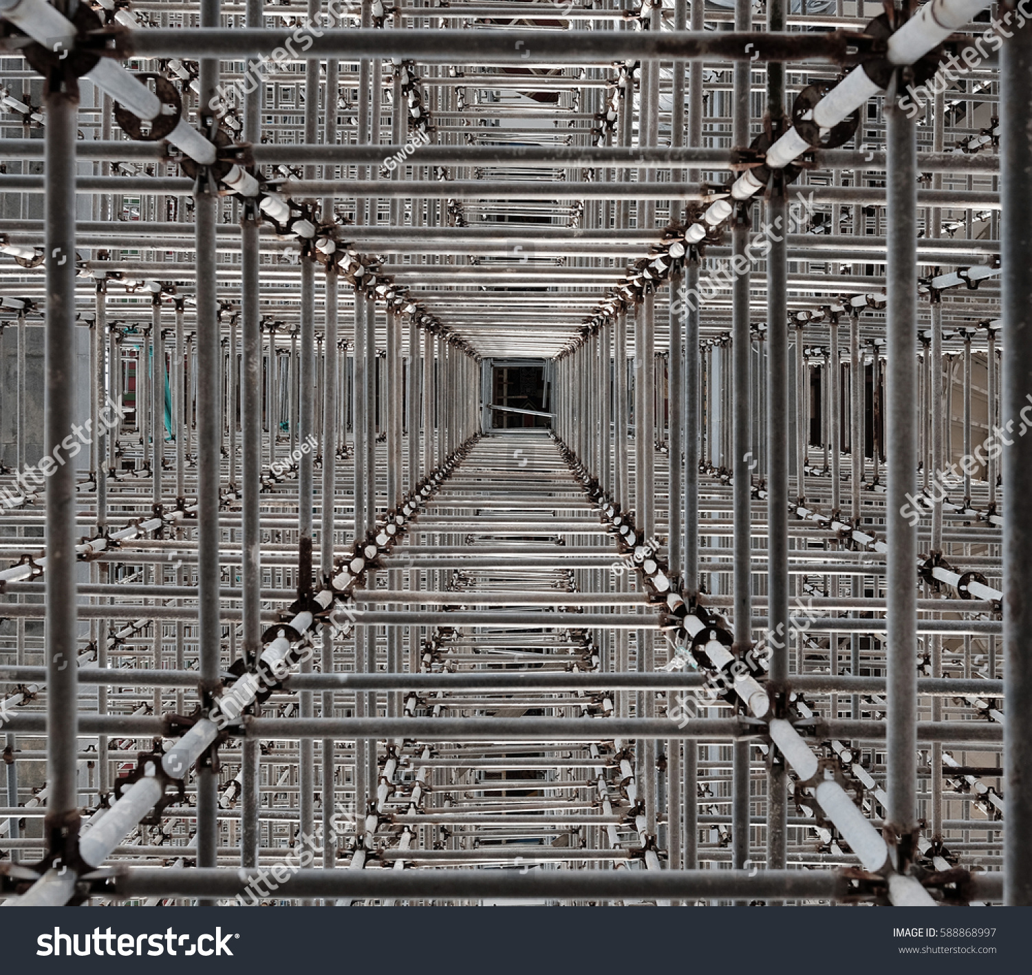 Crisscrossing metal scaffolding frame.
