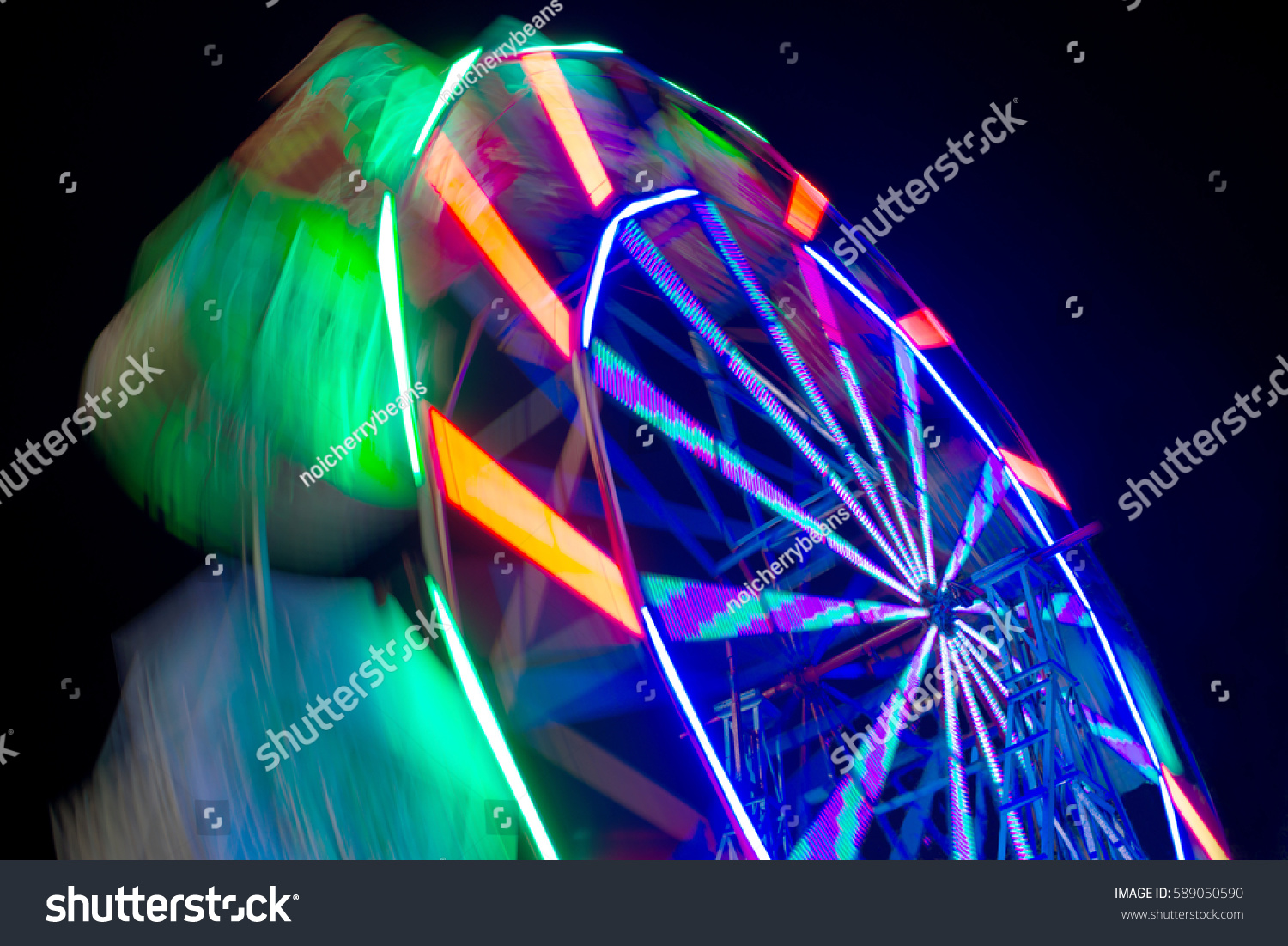 Abstract motion blur ferris wheel spinning at night  long exposure.