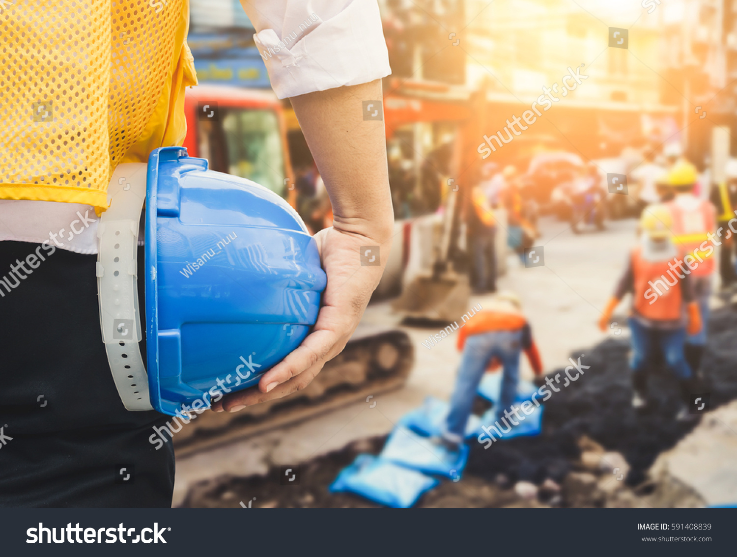 Engineer orders for workers to work safely at construction site workers put
asphalt on the road