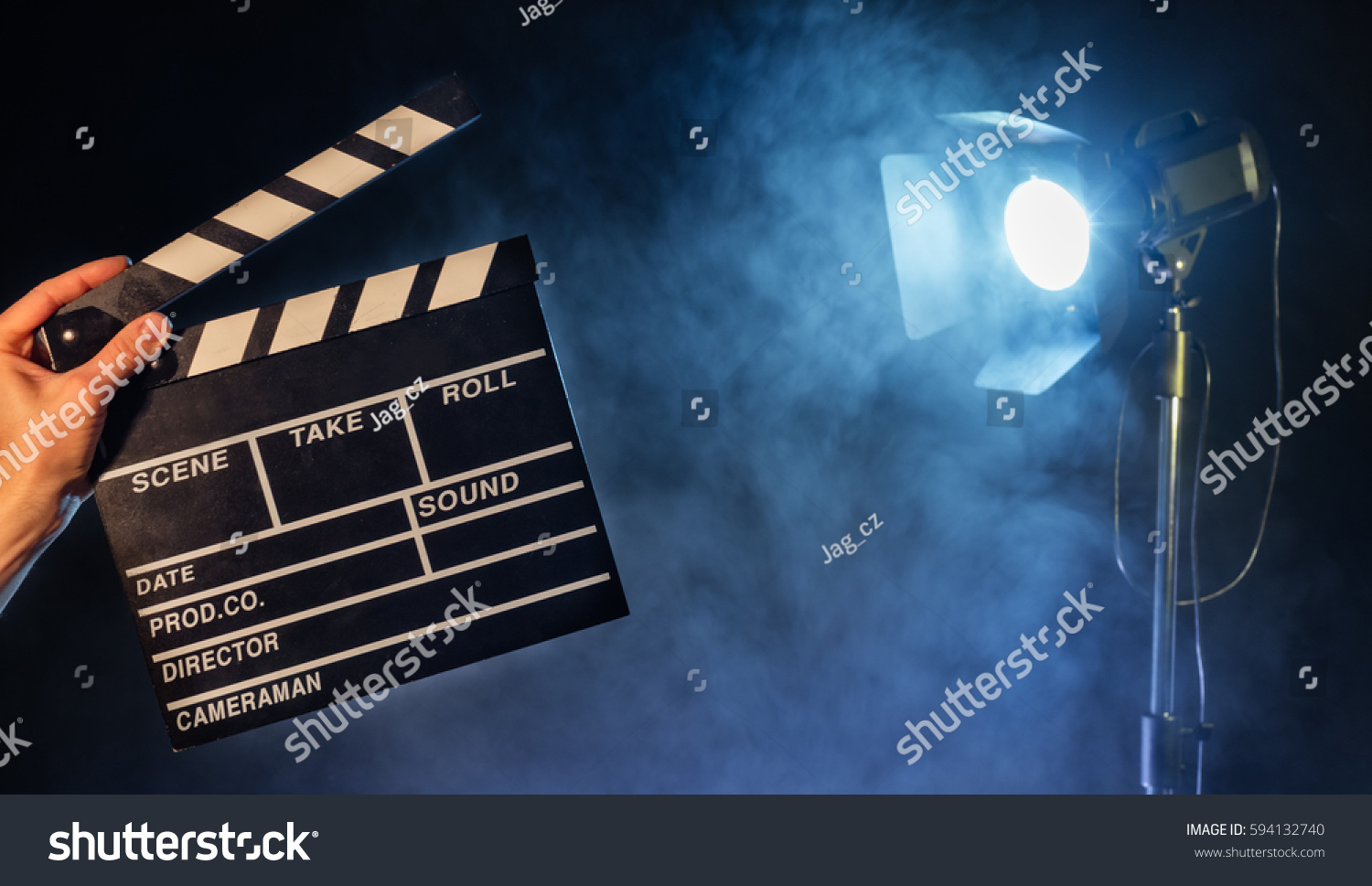 Operator holding clapperboard studio light with claps on background. Filmmaker background
