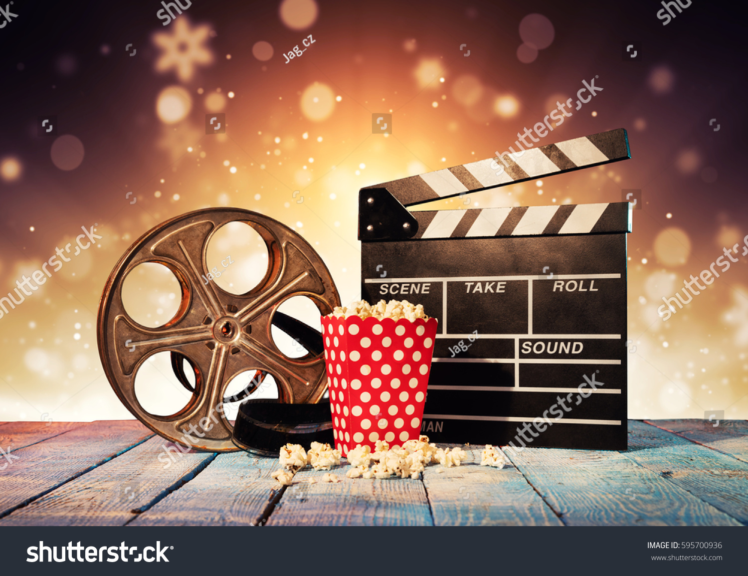 Retro film production accessories placed on wooden planks. Concept of film-making. Blur spot lights on background