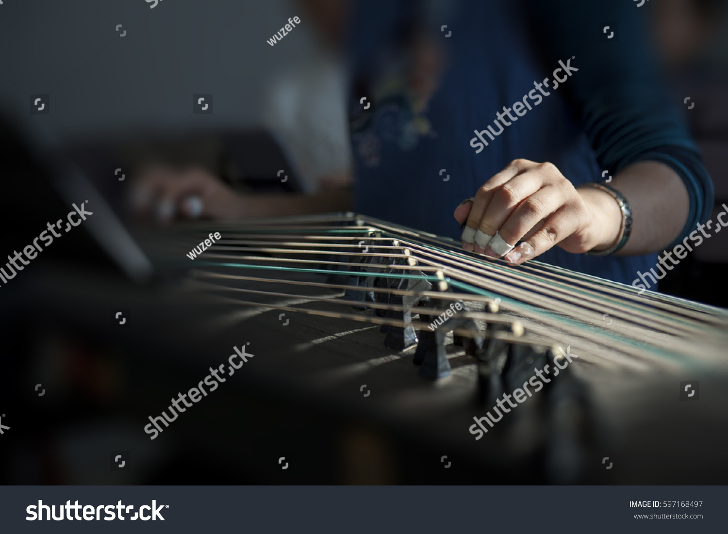hand of woman playing Guzheng.The guzheng or gu zheng also simply
