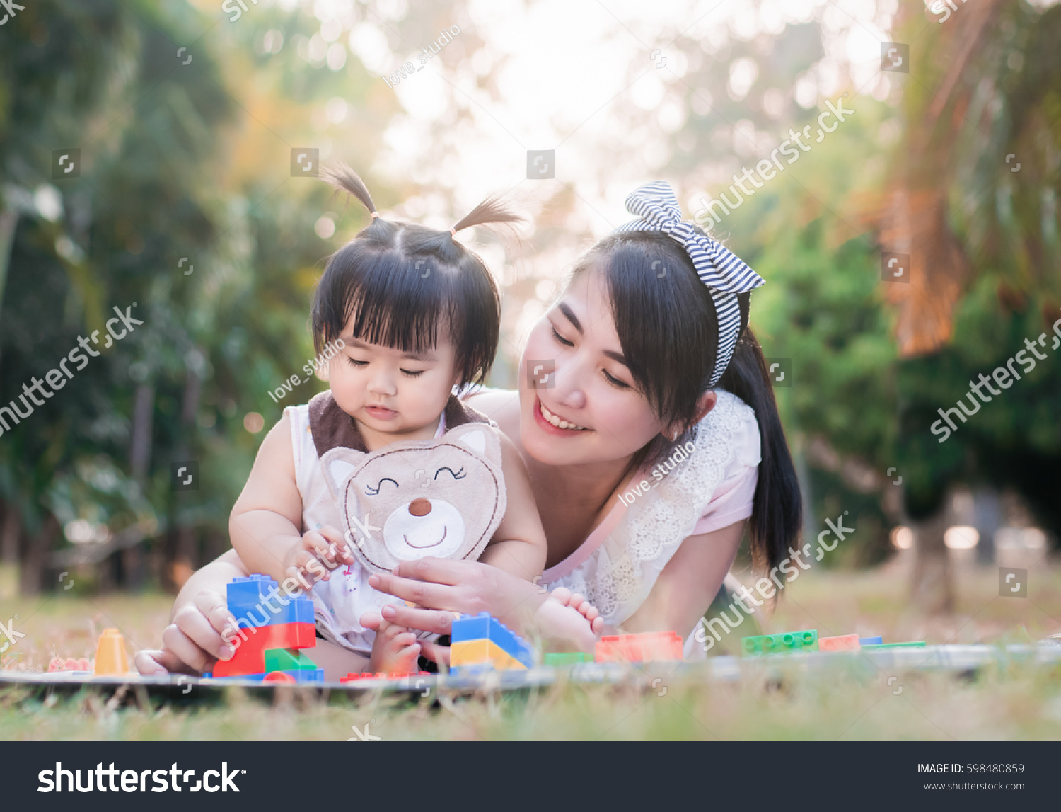 Beautiful asian mom and baby playing toy  happiness in the park   outdoor