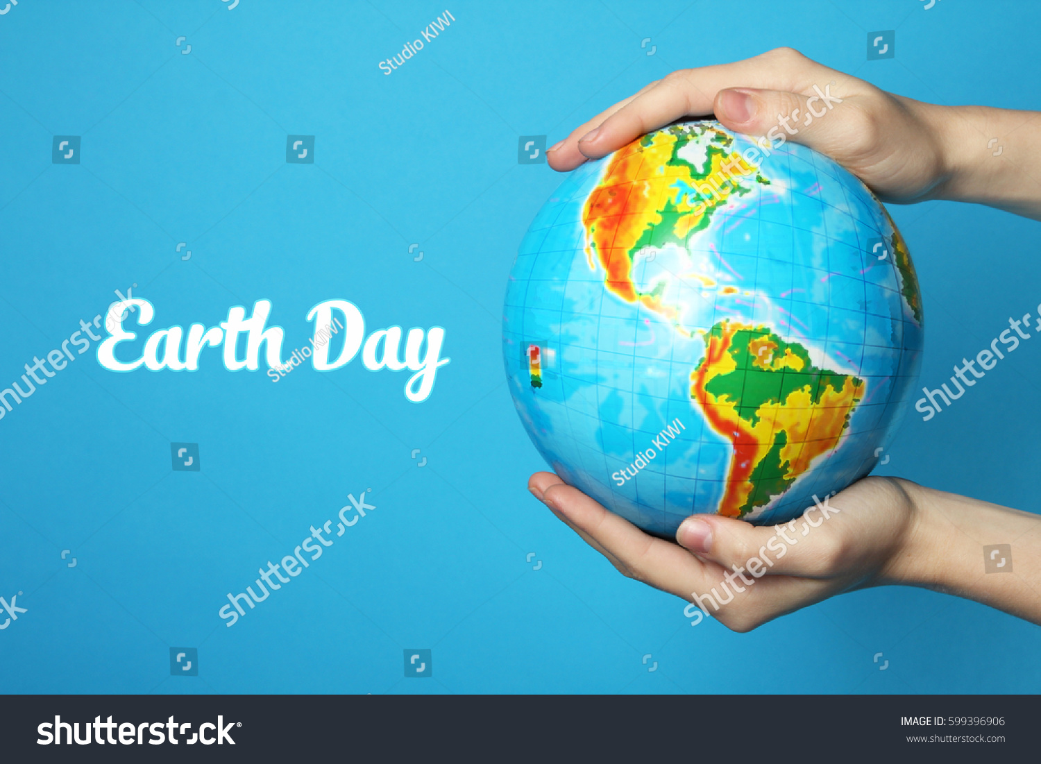  The Earth in hands on blue background. Earth Day.