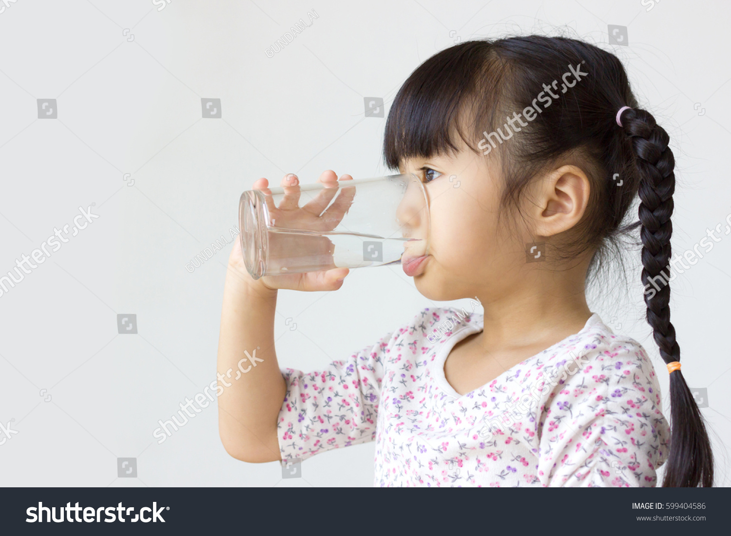 Asian kid drinking water. 