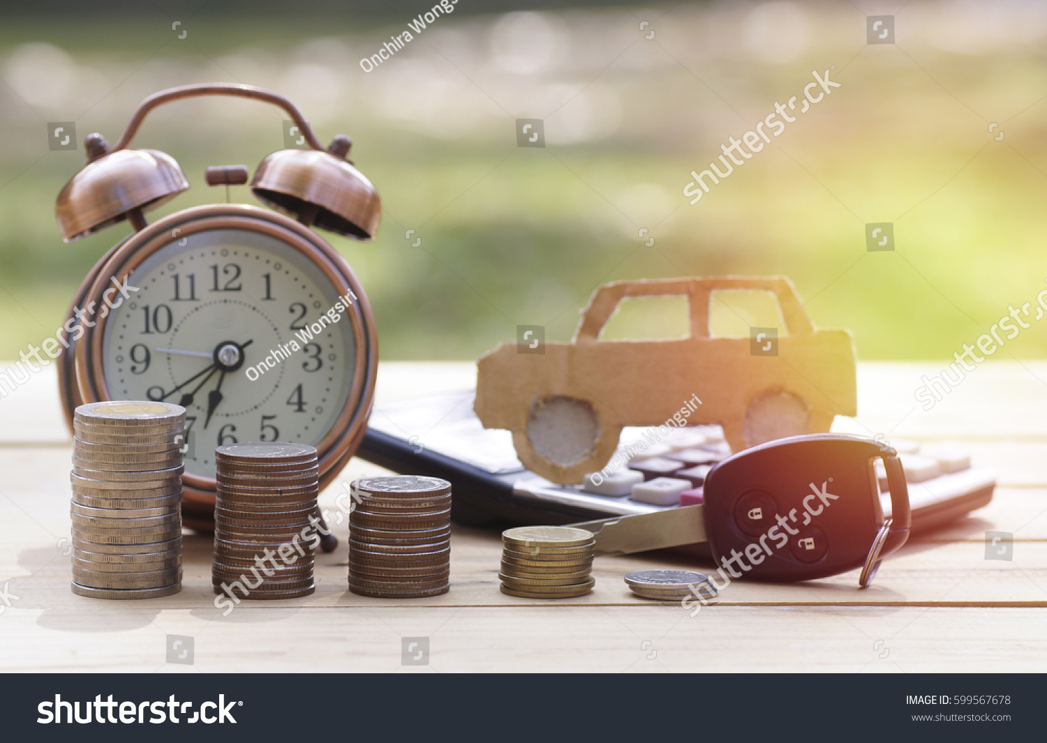 pile of money coins and key  concept in insurance loan finance and buying car background