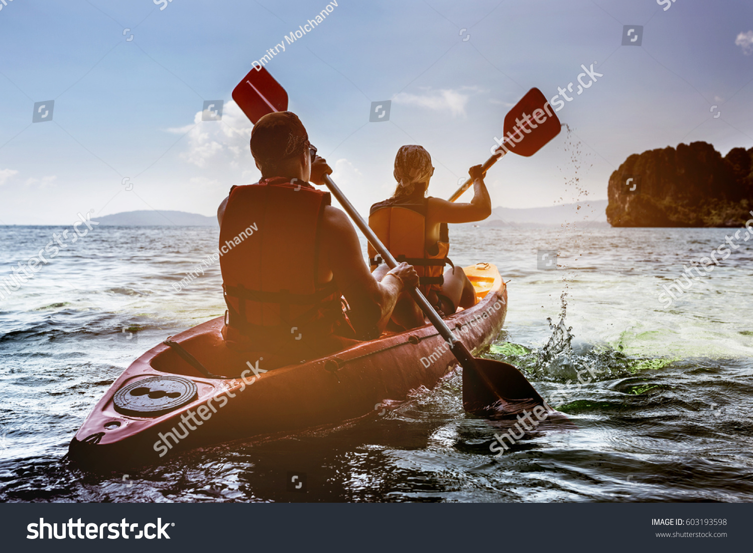 Man and woman swims on kayak in the sea on background of island. Kayaking concept