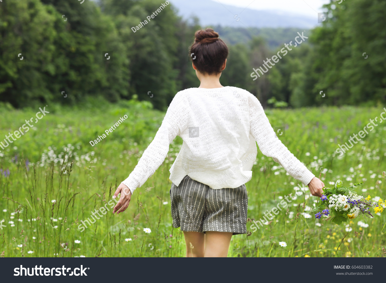 Happy pretty brunette woman in chamomile field cute female relaxed on flowers meadow spring nature having fun outdoor