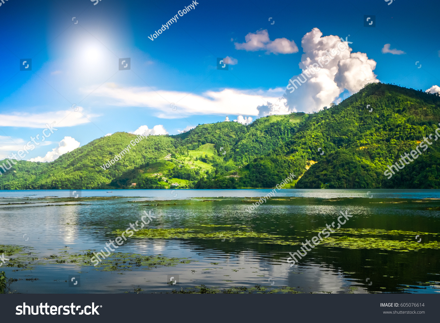 Beautiful green hills landscape with reflection on water at Phewa lake Pokhara. Relax after trekking in Himalaya mountains Nepal. Nature landscape. Travel background. Holidays and recreation