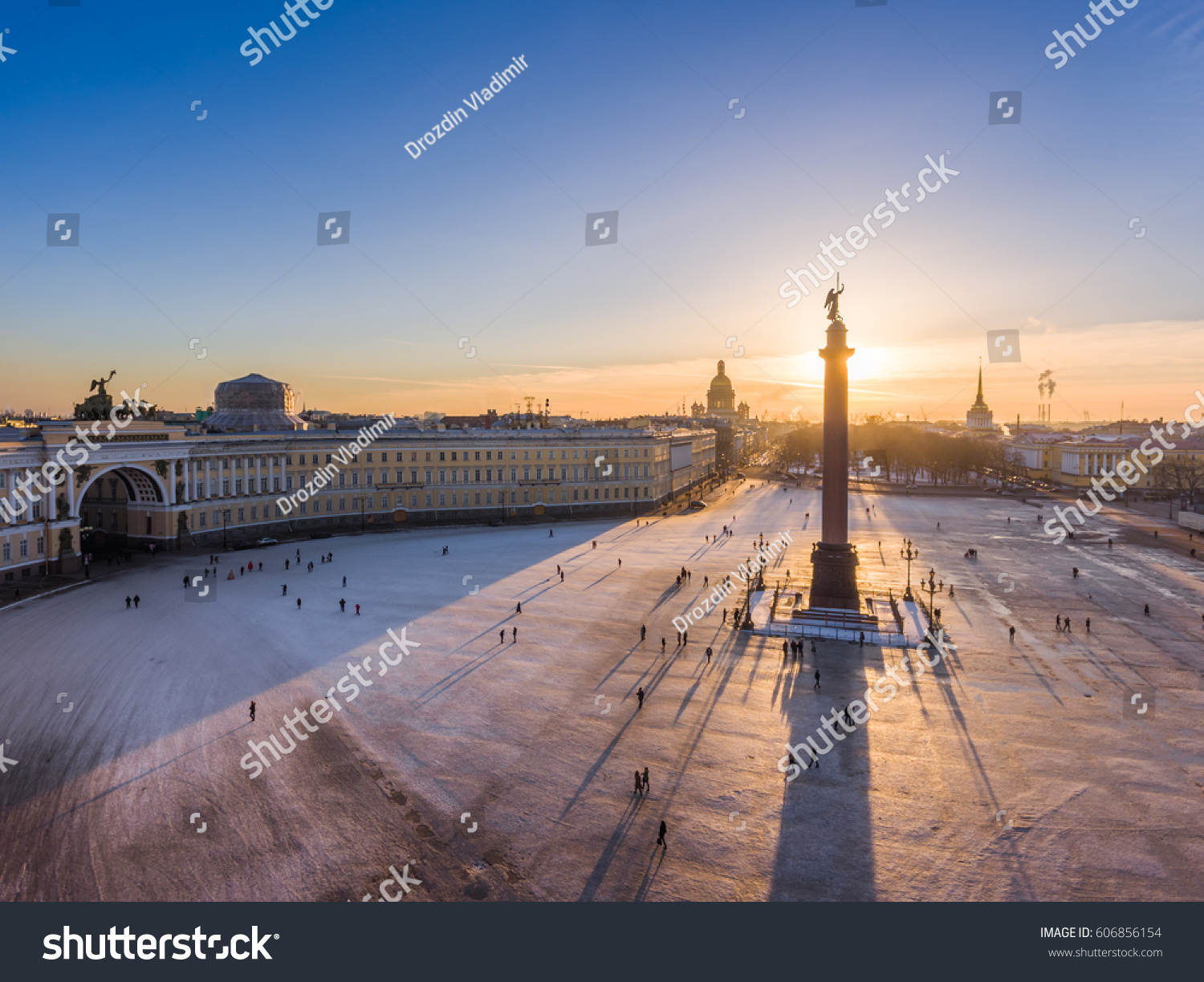 Aerial view of Palace Square and Alexander Column at sunset a gold dome of St. Isaac's Cathedral the Winter Palace the Hermitage Peter and Paul fortress triumphal chariot little people walks