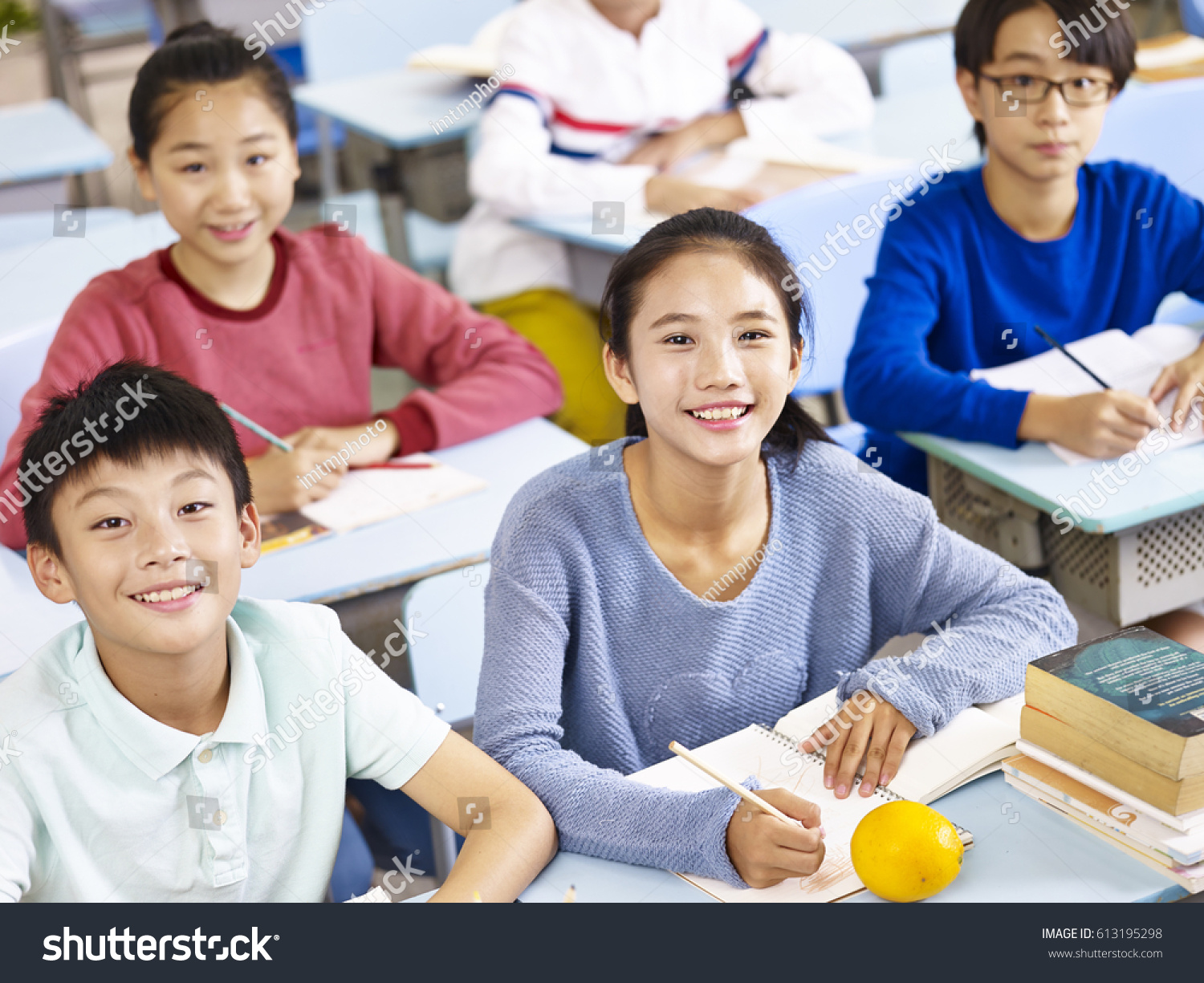 asian grade school students sitting in classroom  high angle view.