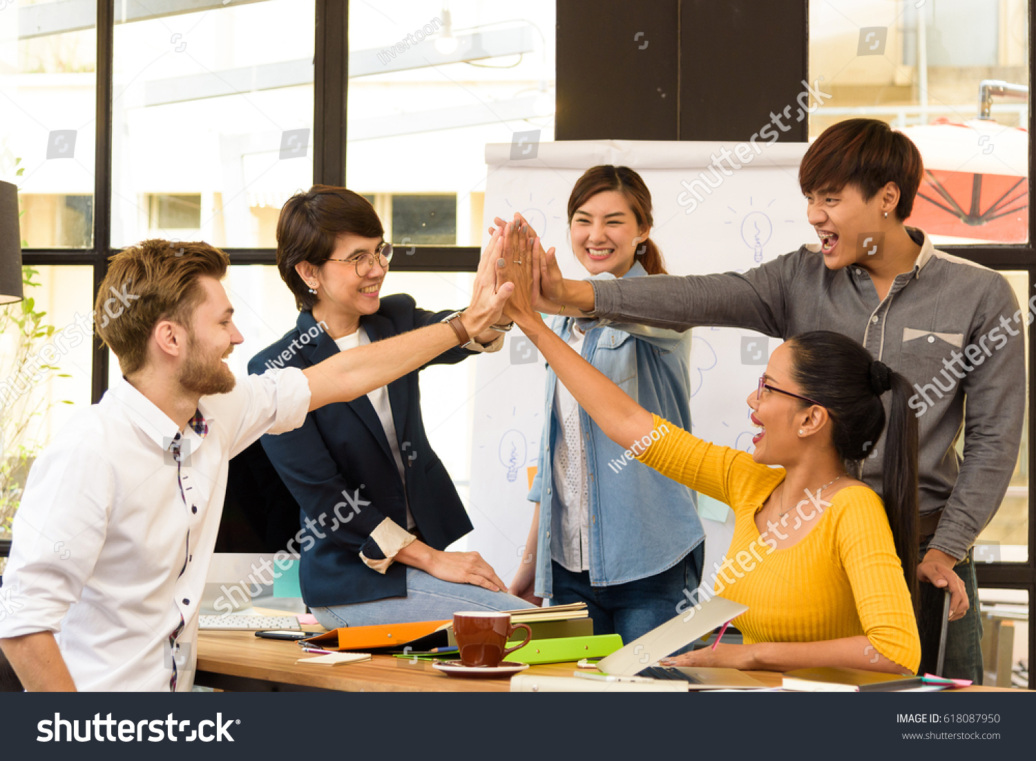 Multi ethnic business person group in casual suit celebrate after their project successful in modern office. Project and Business concept.