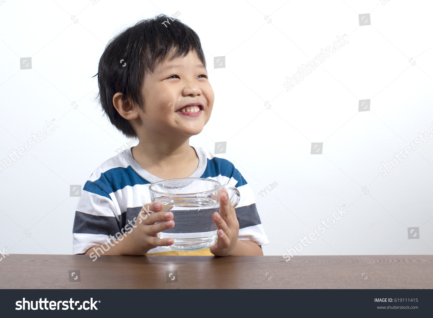 Cute little asian boy drink water