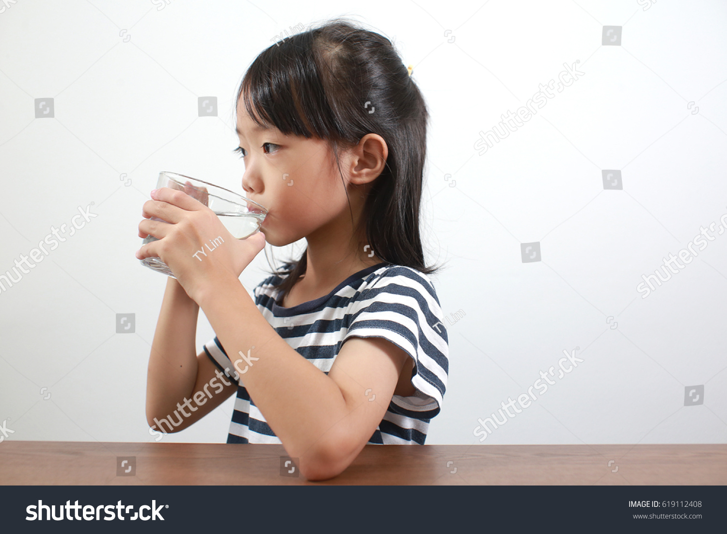 Cute little asian girl drink water