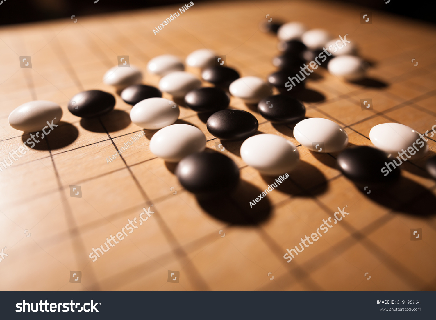 Close up shot of a Go board game  with black and white stones.