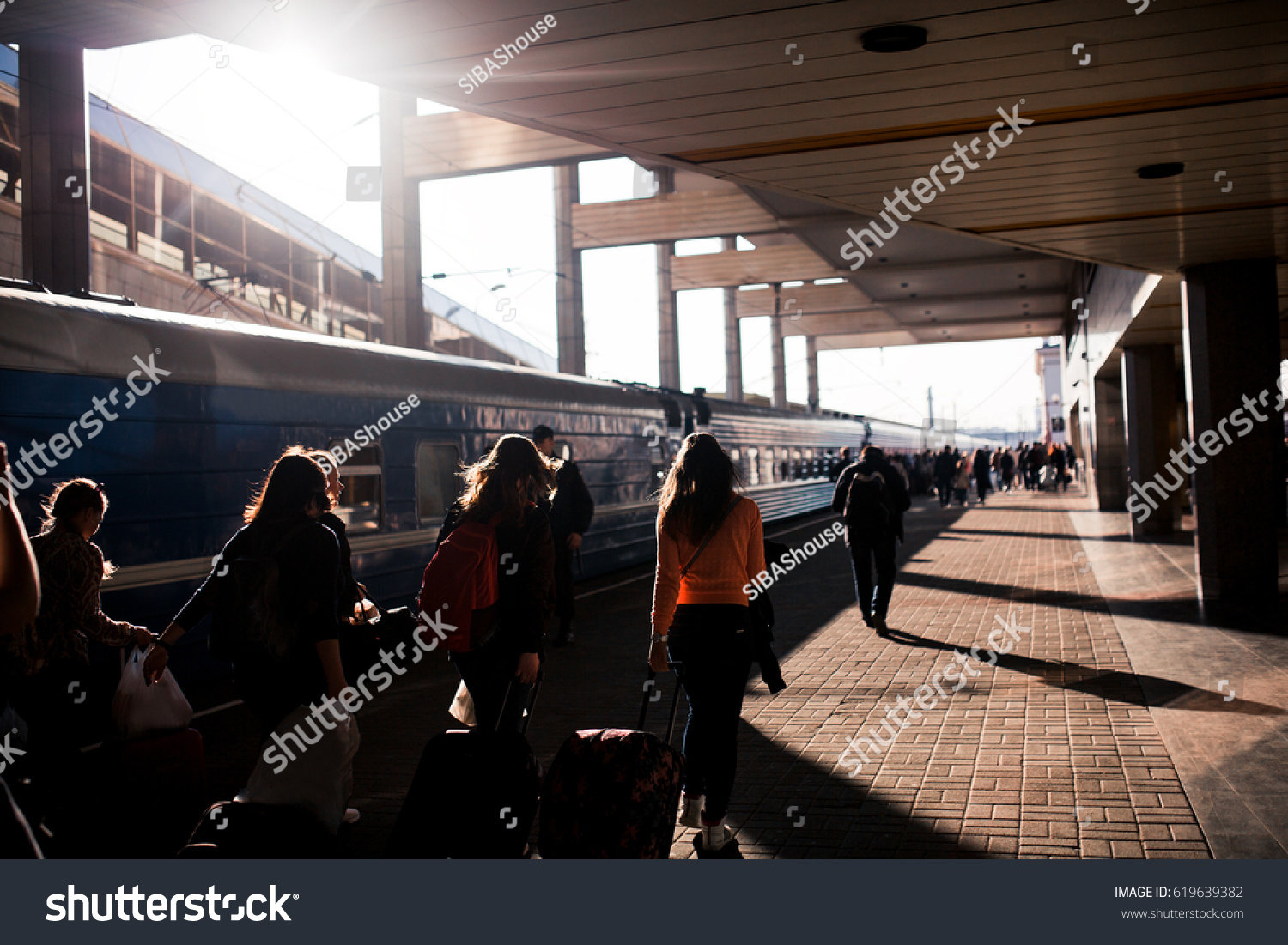 Railway station in the city with Silhouettes of running people.