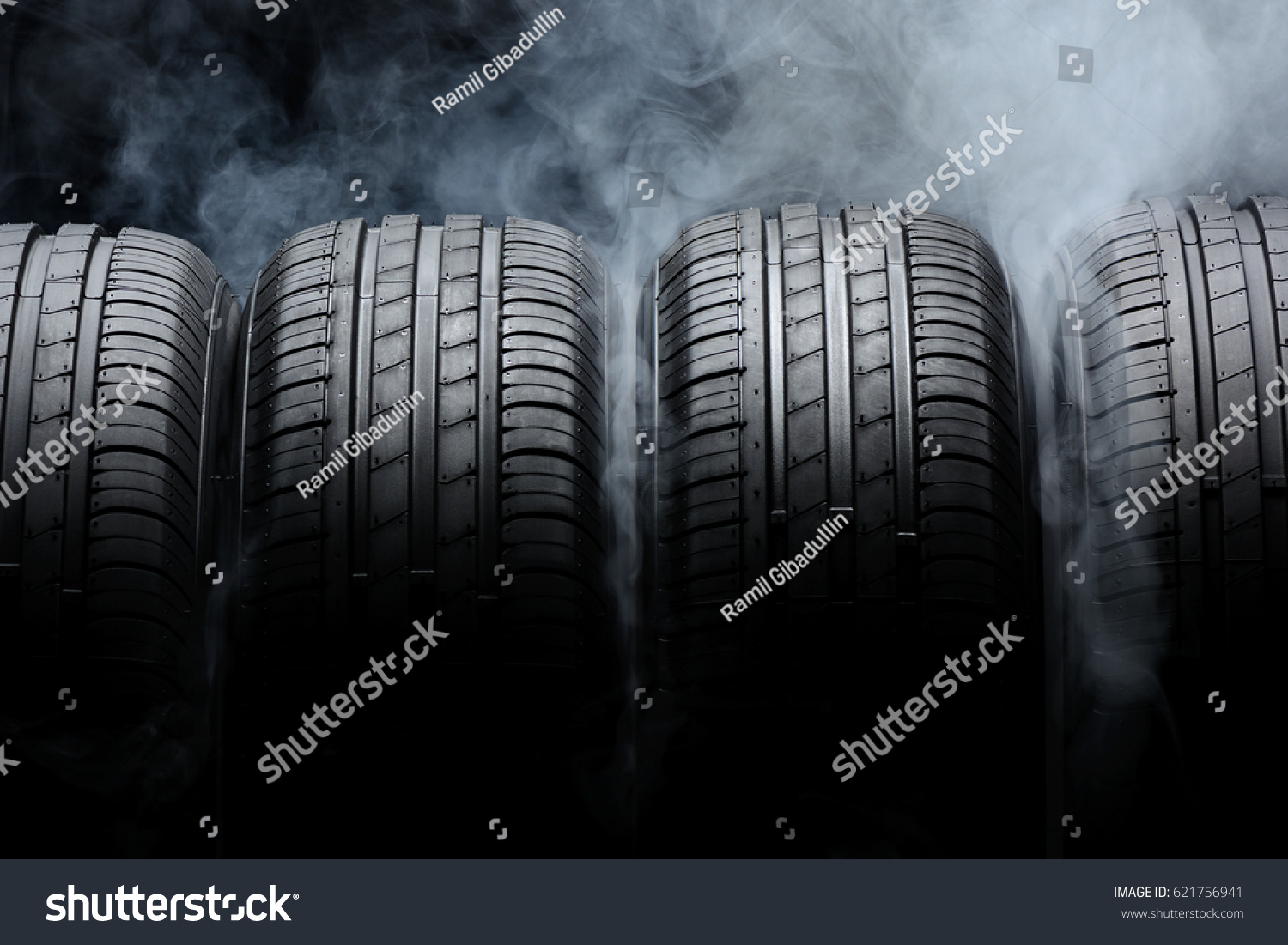 Car tires and smoke on black background