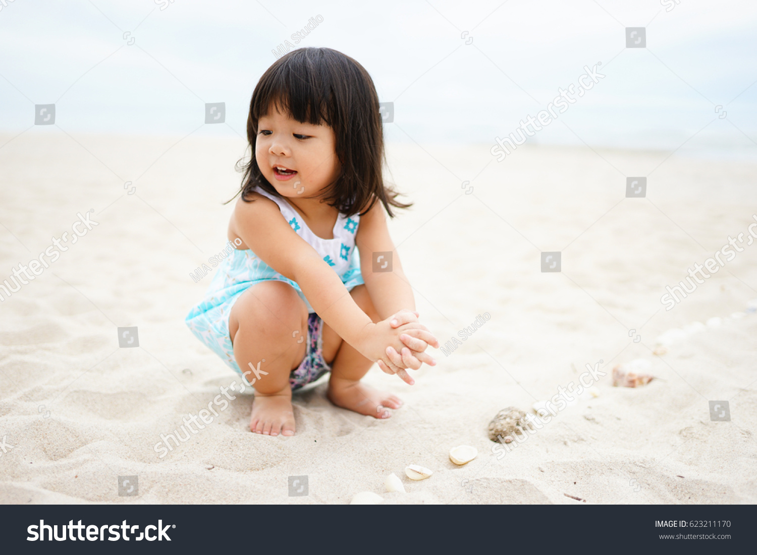 Little asian girl playing on the beach.Vacation and relax concept.