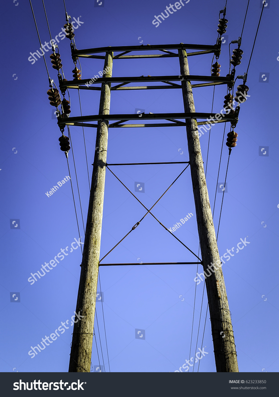 telegraph pole against a vivid blue sky