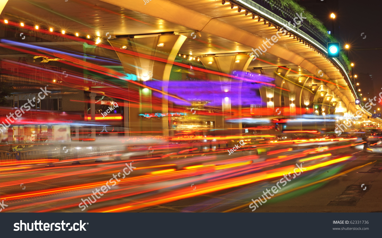 High speed traffic and blurred light trails under the overpass at night scene