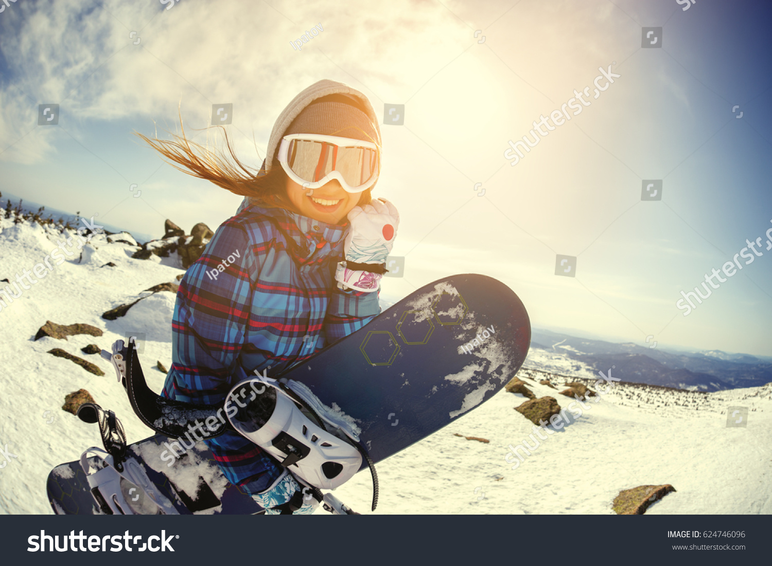 Girl snowboarder enjoys the ski resort. Sheregesh. Russia.