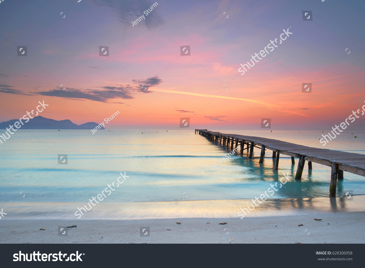 amazing sunrise at wooden Pier on the beach                                       