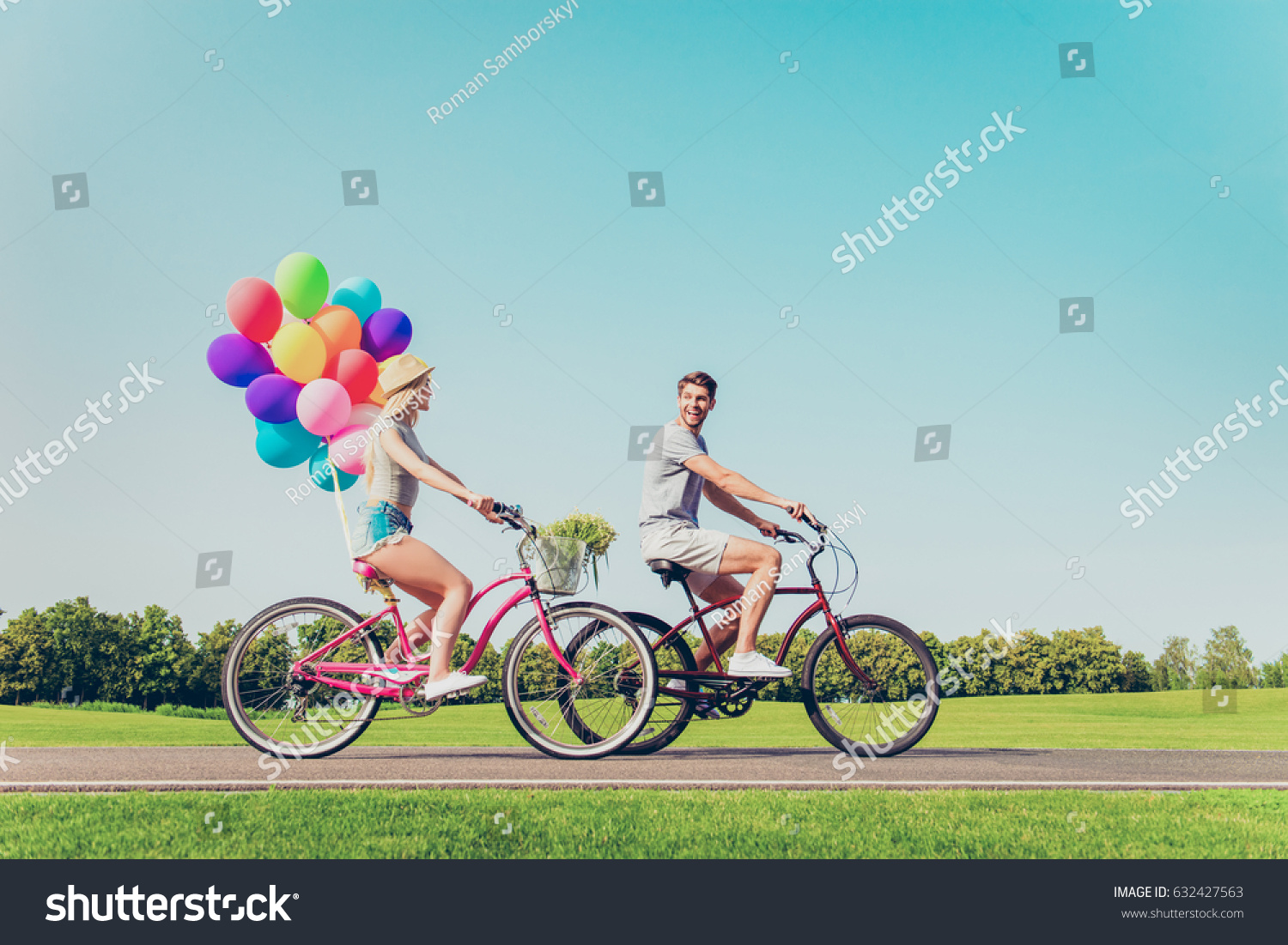 Happy family having summer weekend and riding bicycles