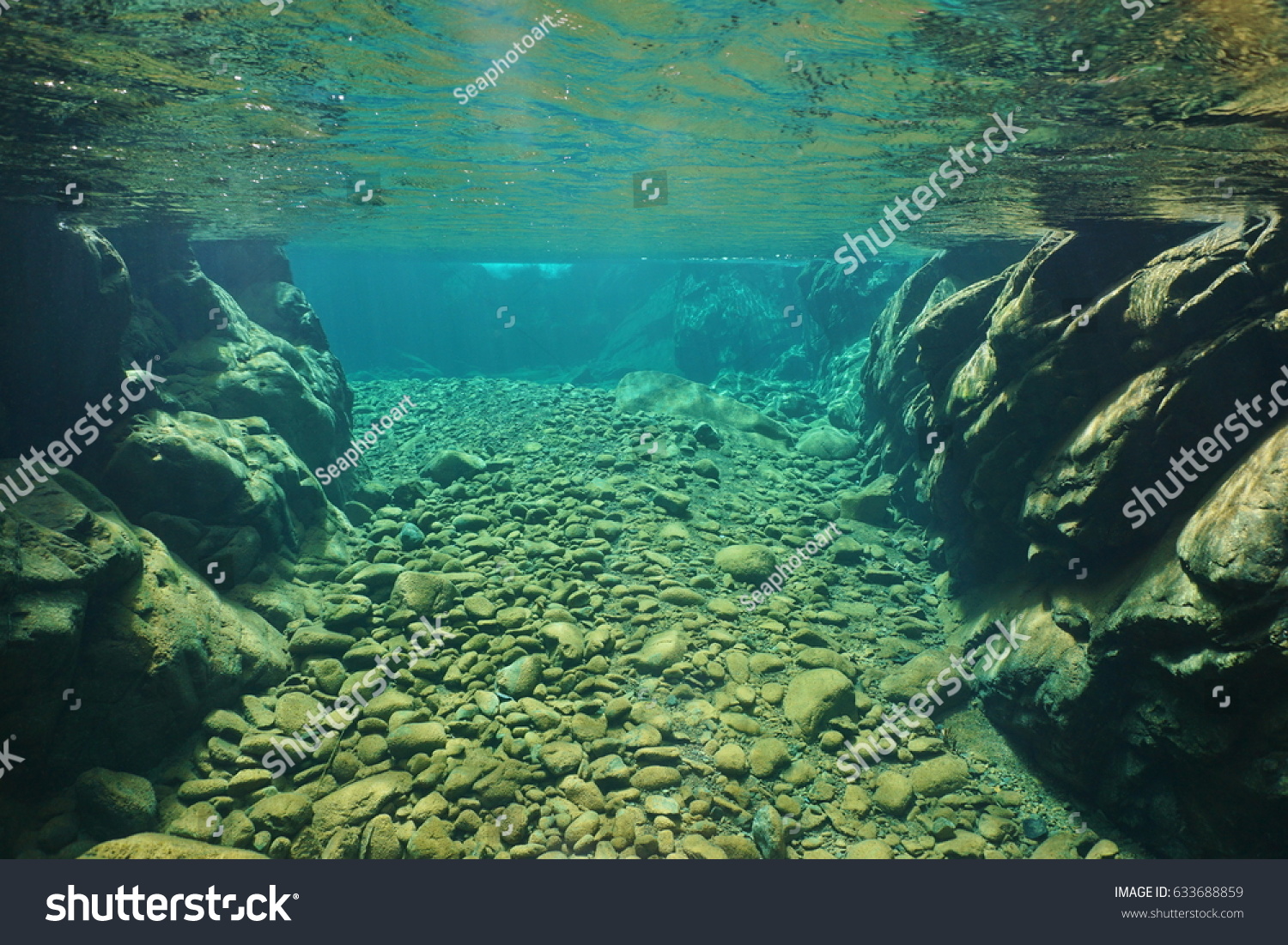Rocks and pebbles underwater in a river with clear freshwater Dumbea New Caledonia south Pacific
