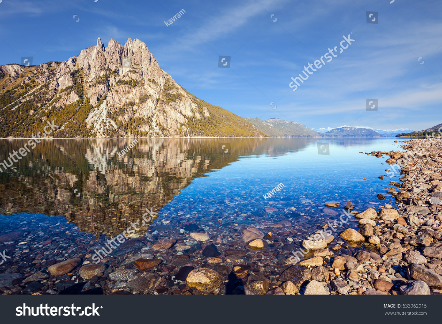 Picturesque mountain in the city of San Carlos de Bariloche Argentina. The mirror water of shallow lake reflects sharp rocks. The concept of exotic and extreme tourism