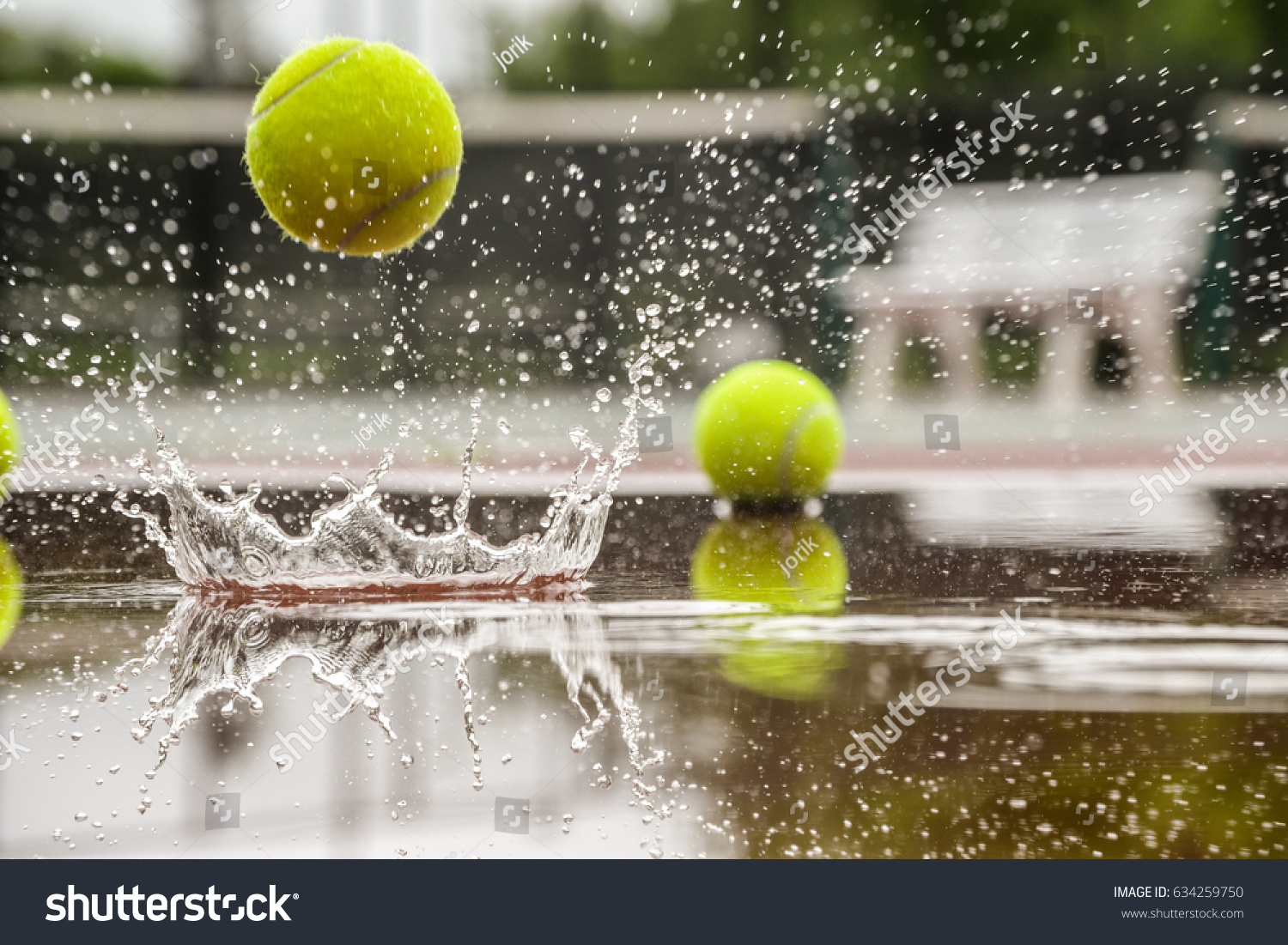 Tennis court. Hard court in raining weather. Yellow tennis ball bouncing