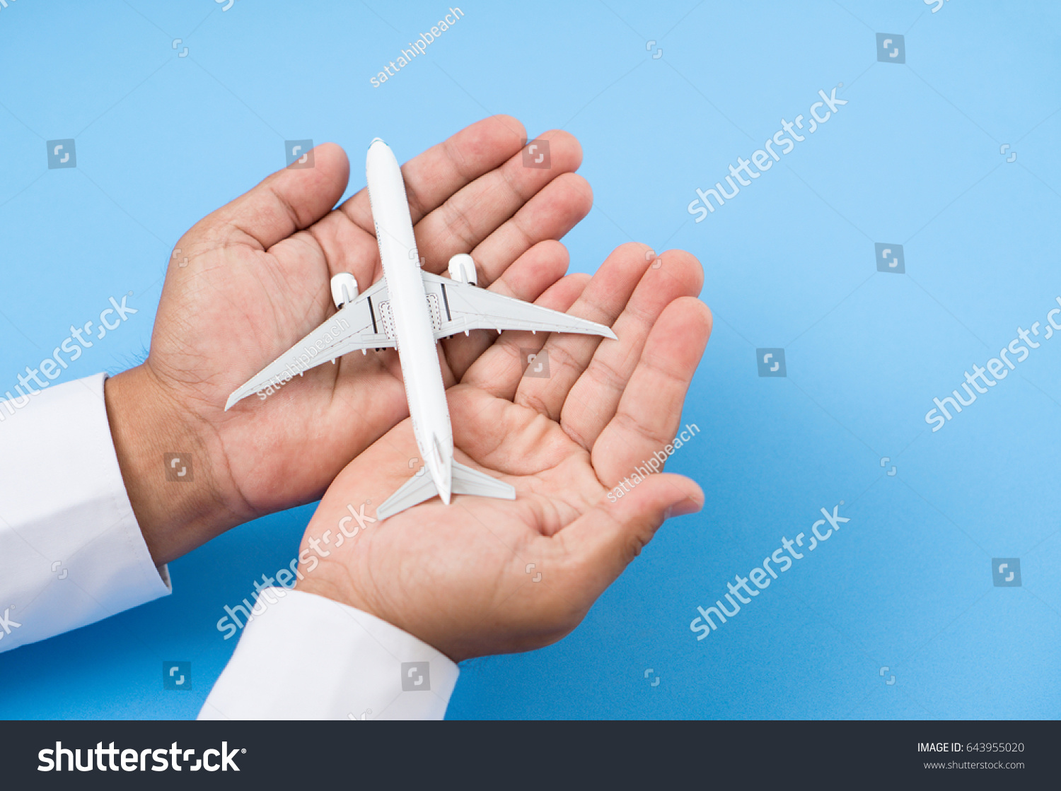 hands support airplane model  travel insurance concept.