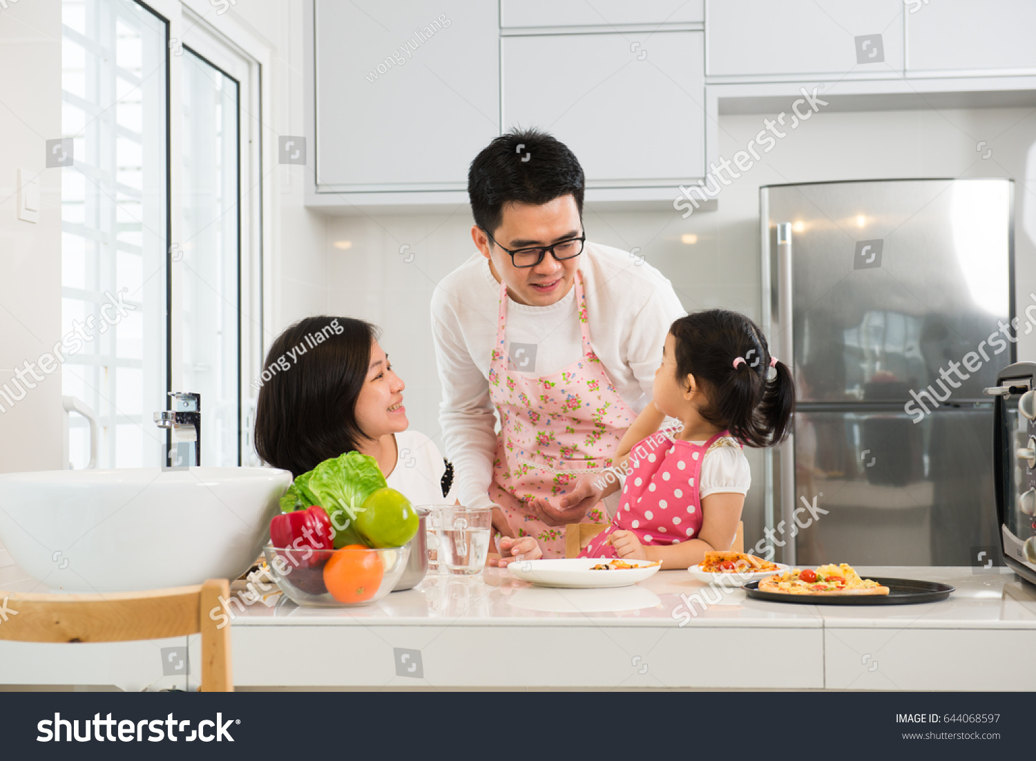 asian family cooking at kitchen

