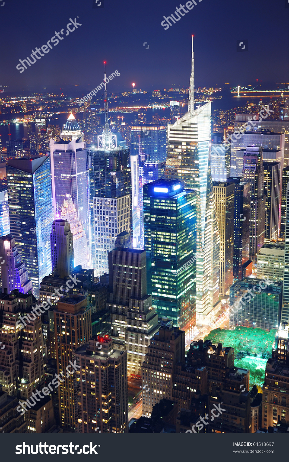 New York City Manhattan Times Square panorama aerial view at night with office building skyscrapers skyline illuminated by Hudson River.