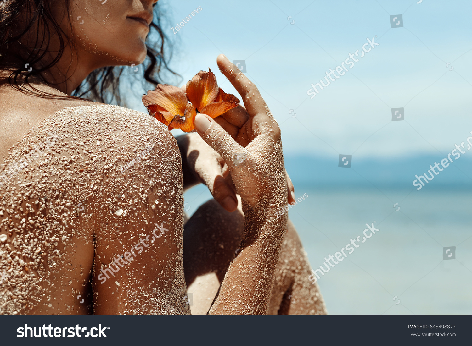 Close up of woman hands holding flower. Spa vacation concept