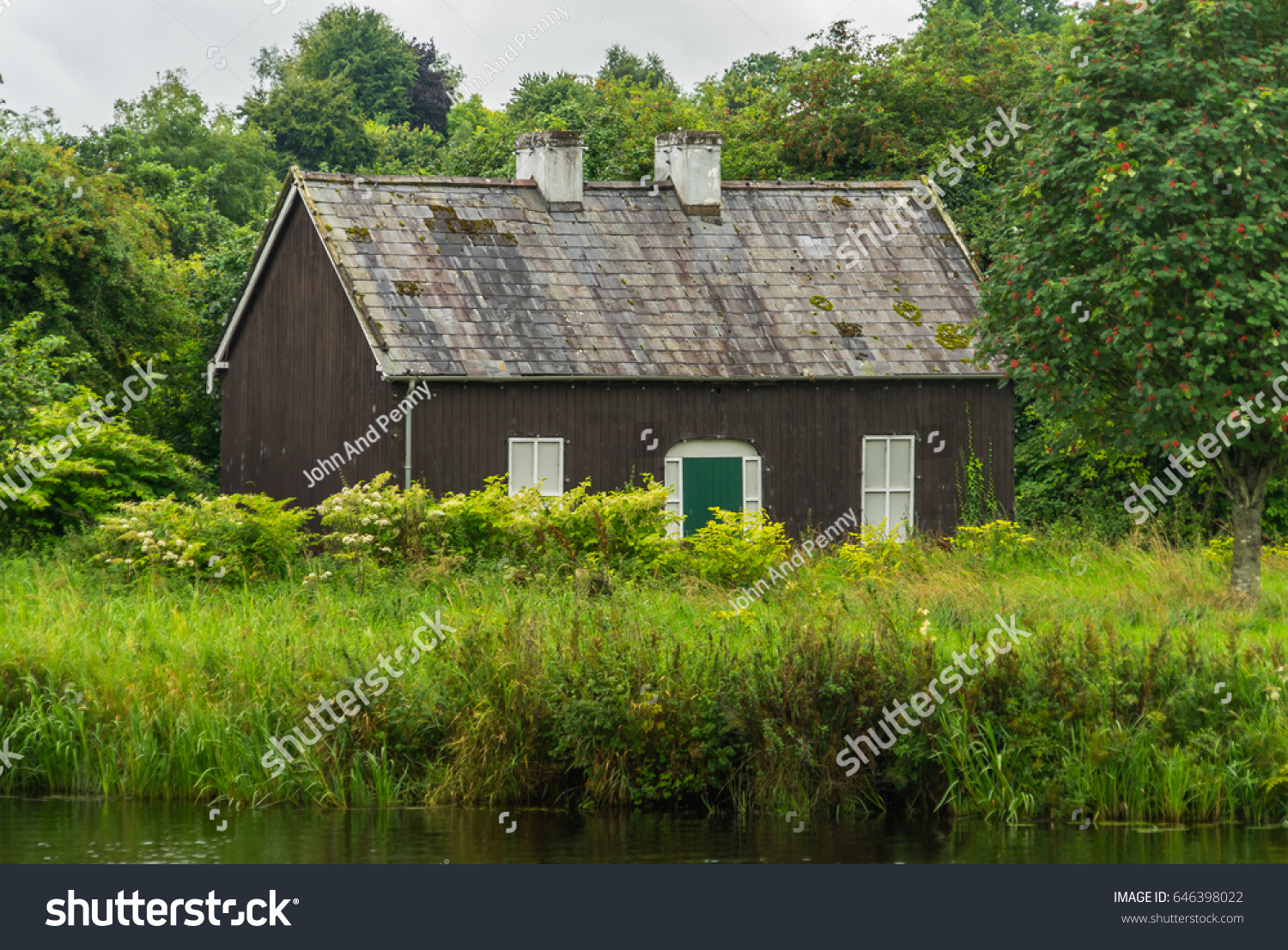 Small house surrounded by green grass and woods  outside Enniskillen  Northern Ireland.