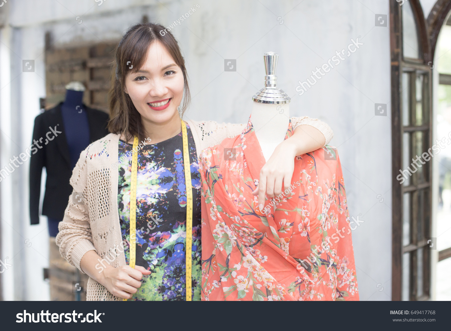 Beautiful young asian designer in her dress fashion at showroom  20s age