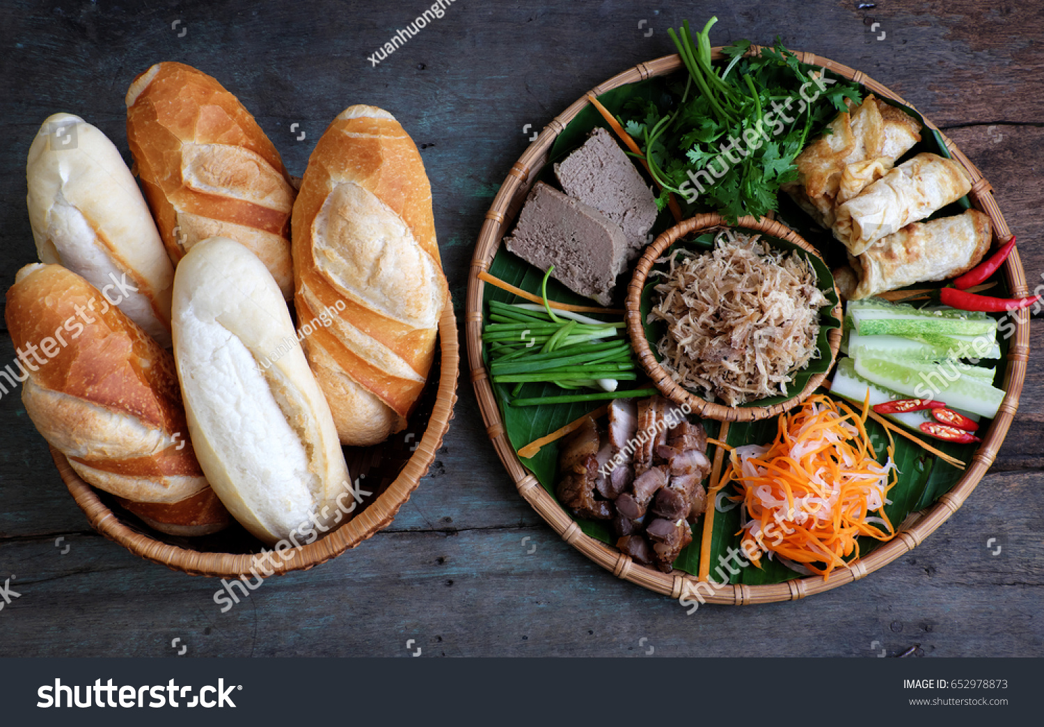 Famous Vietnamese food is banh mi thit  popular street food from bread stuffed with raw material: pork  ham  pate  egg and fresh herbs as scallions  coriander  carrot  cucumber  chilli.