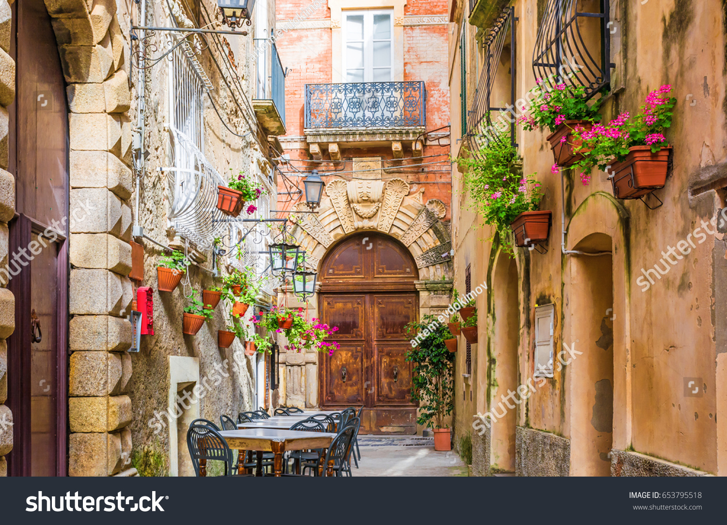 Cafe tables and chairs outside in old cozy street in the Positano town  Campania  Italy