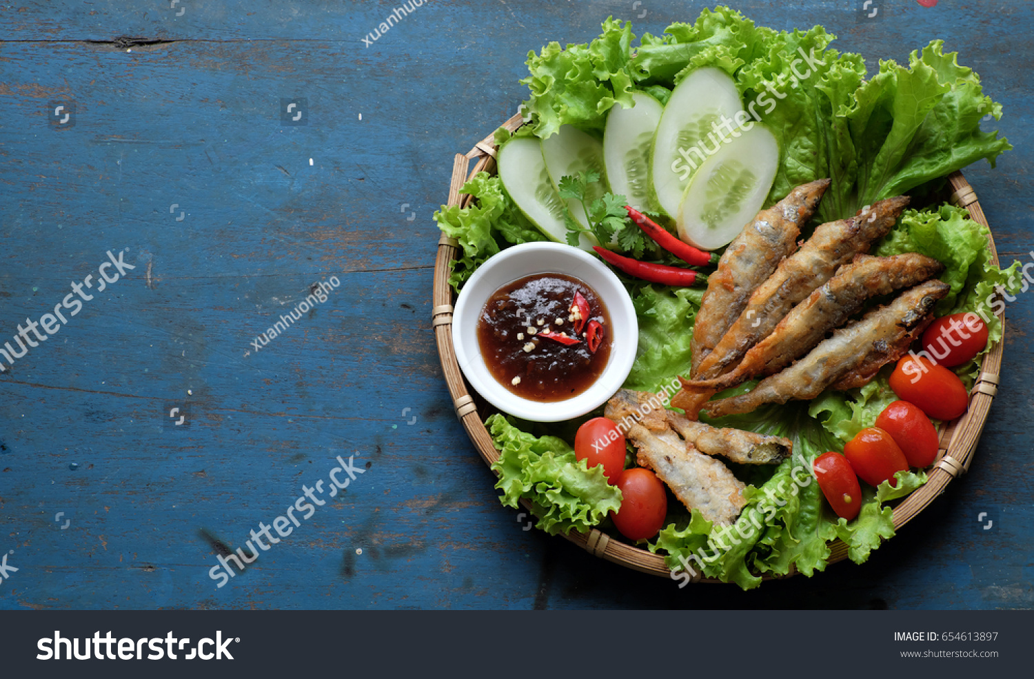 Vietnamese food for family meal at lunch or dinner  fried fish with tamarind sauce and green vegetable  delicious food homemade on wooden background