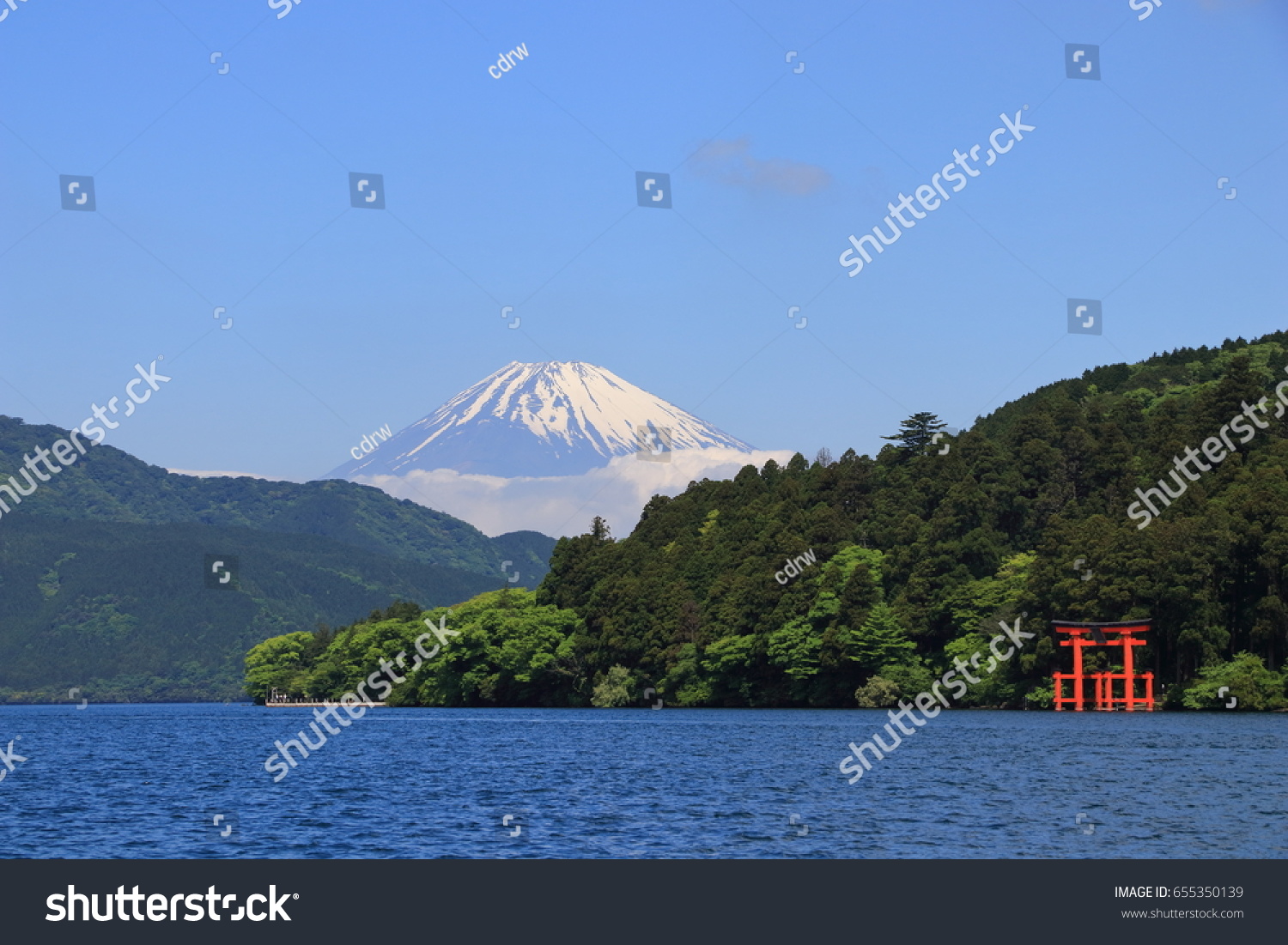 Mt. Fuji and a big red Torii (Gate to the Hakone Shrine) on the Ashinoko Lake under a clear sunny sky. Photoed in Hakone  Japan.