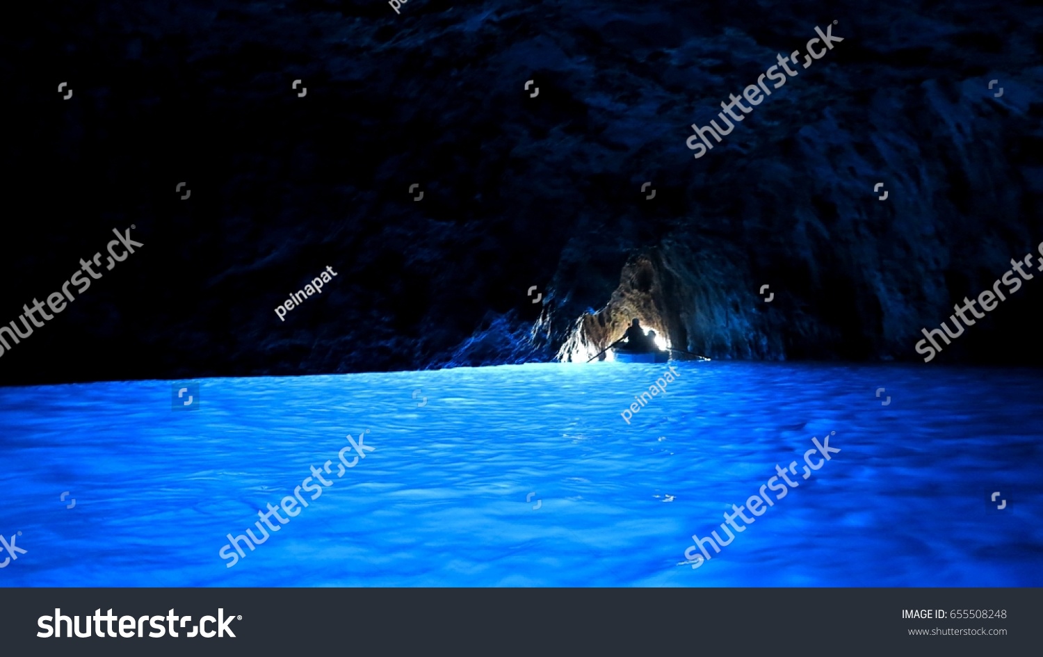 A silhouette of a boat at the exit of Blue grotto cave  Capri  Italy
