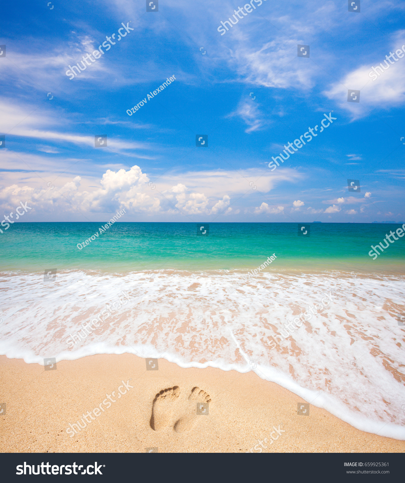 footprints on beach and tropical sea