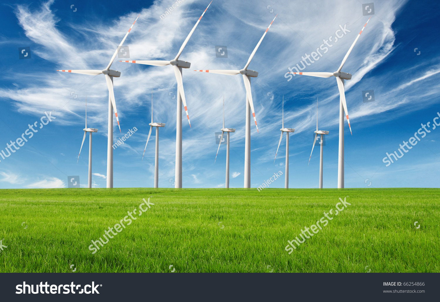 windmills with fresh green grass and beautiful blue sky