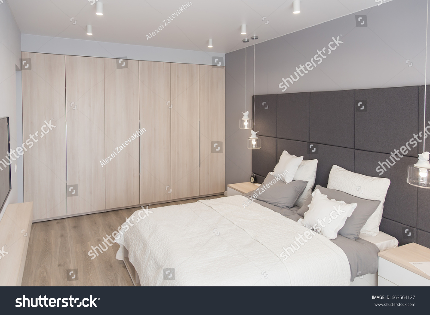Interior of the room in light colors. Bedroom with bed and lighting