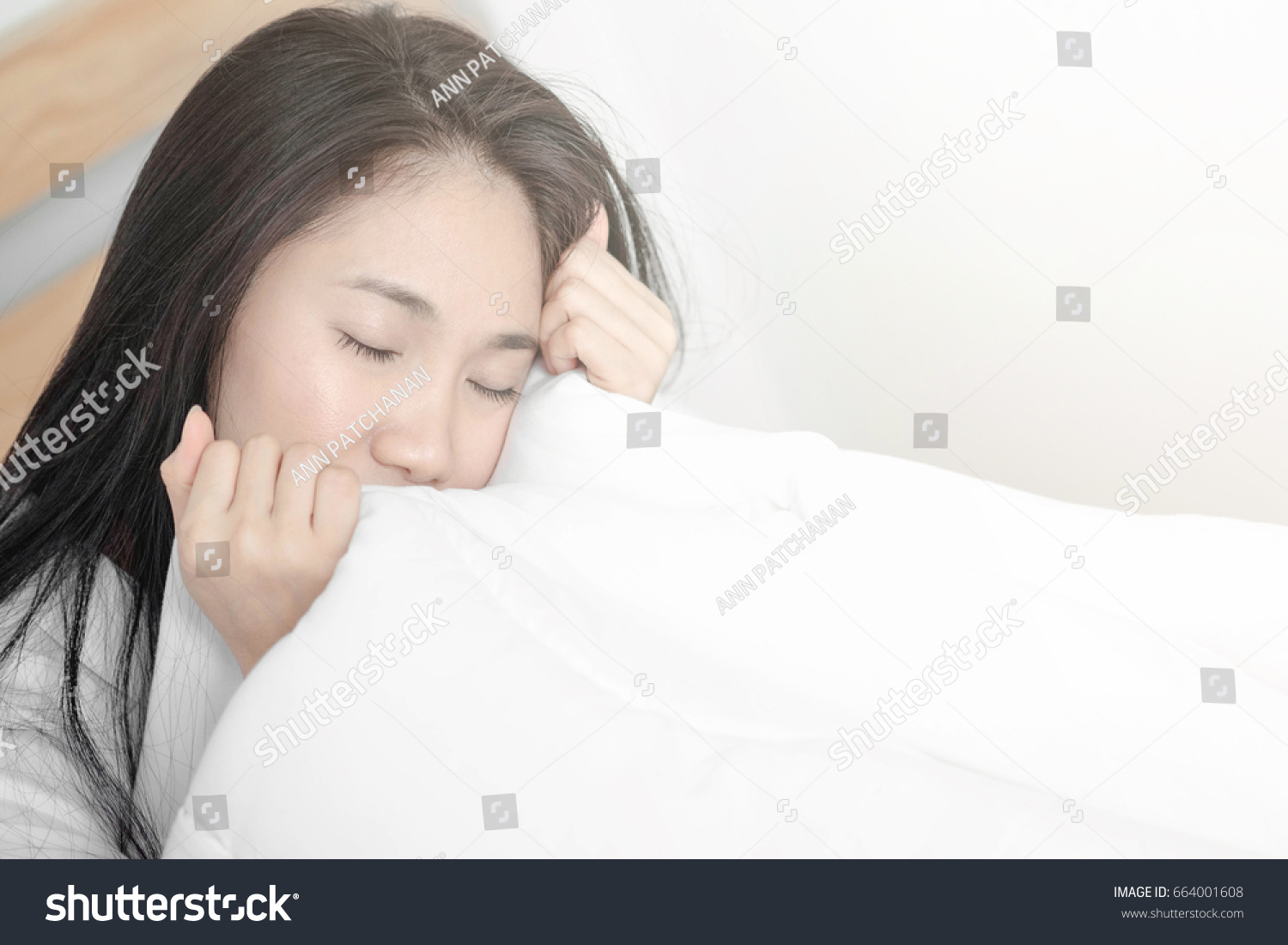 Asian girl in bed. Lazy to get up Wake up in the morning