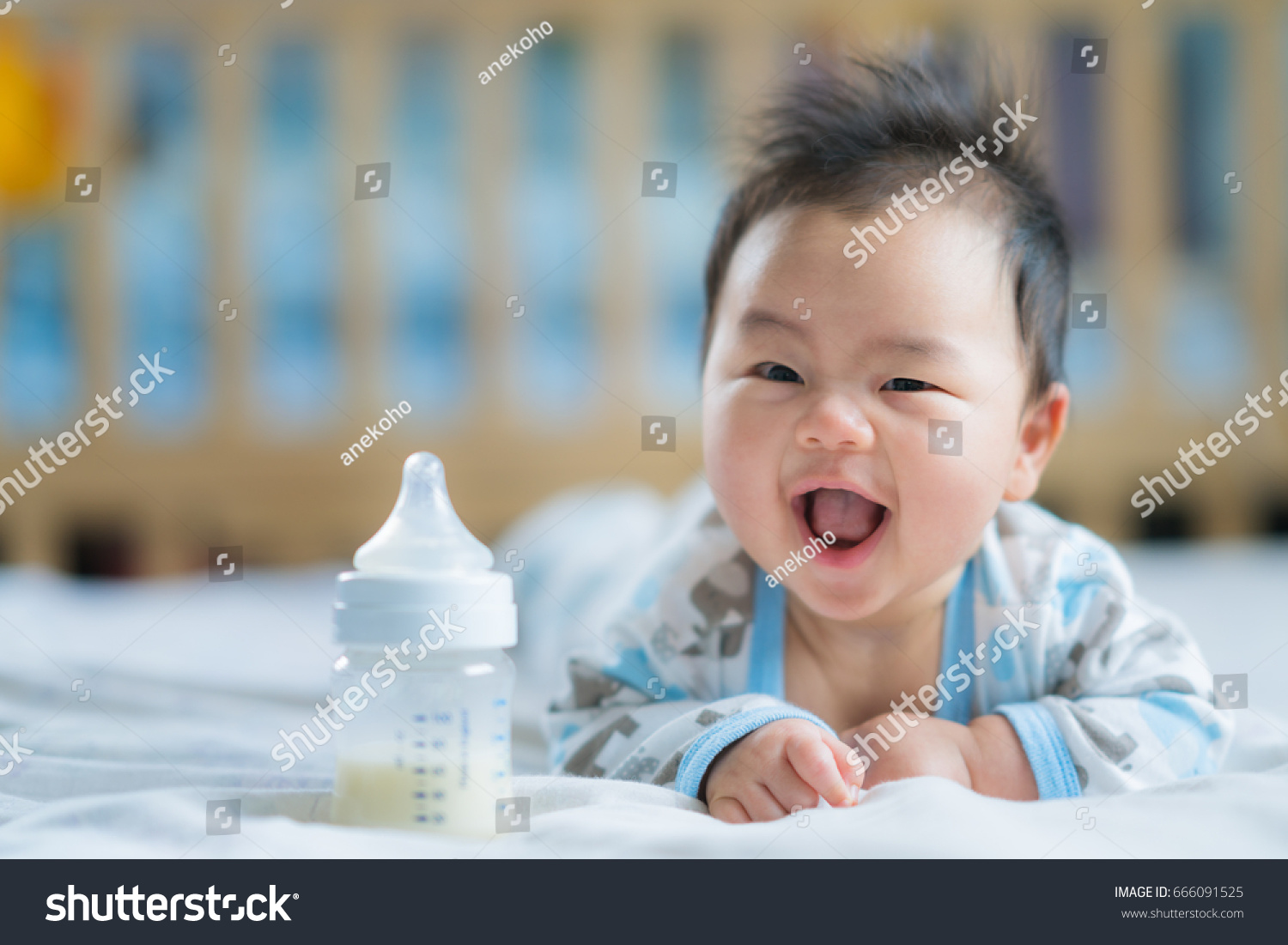 Asian Newborn baby smile with milk power bottle  baby  boy  mom  mother concept