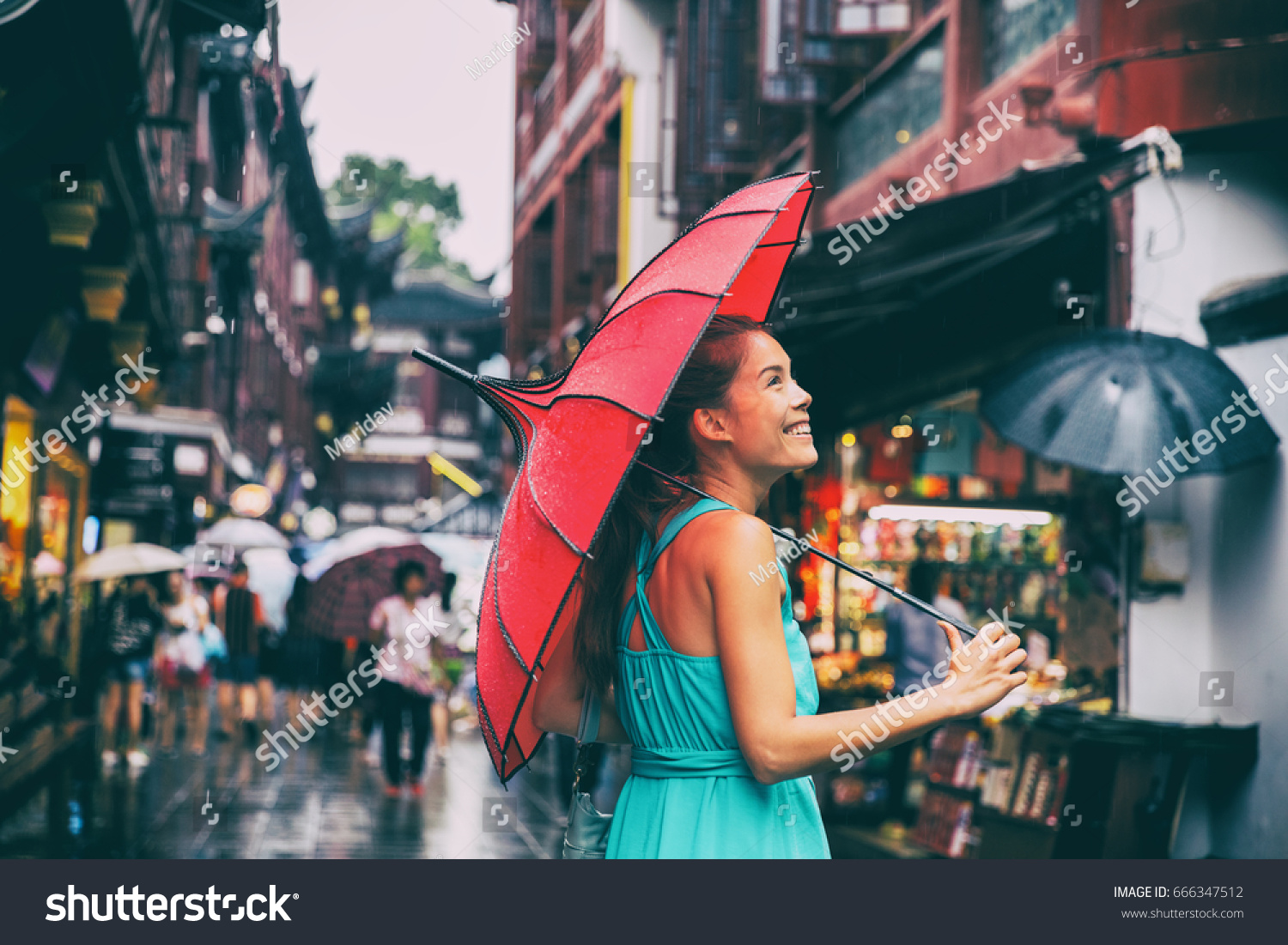 People lifestyle umbrella travel Asian woman shopping in chinatown market street. Rainy day girl tourist under red oriental umbrella in back alleys in Shanghai  China.