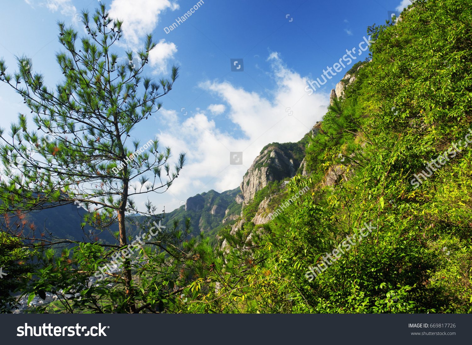 A low hanging cloud against blue sky in the early morning at Fangdong Scenic Area on Yandangshan mountains located in Zhejiang province China.
