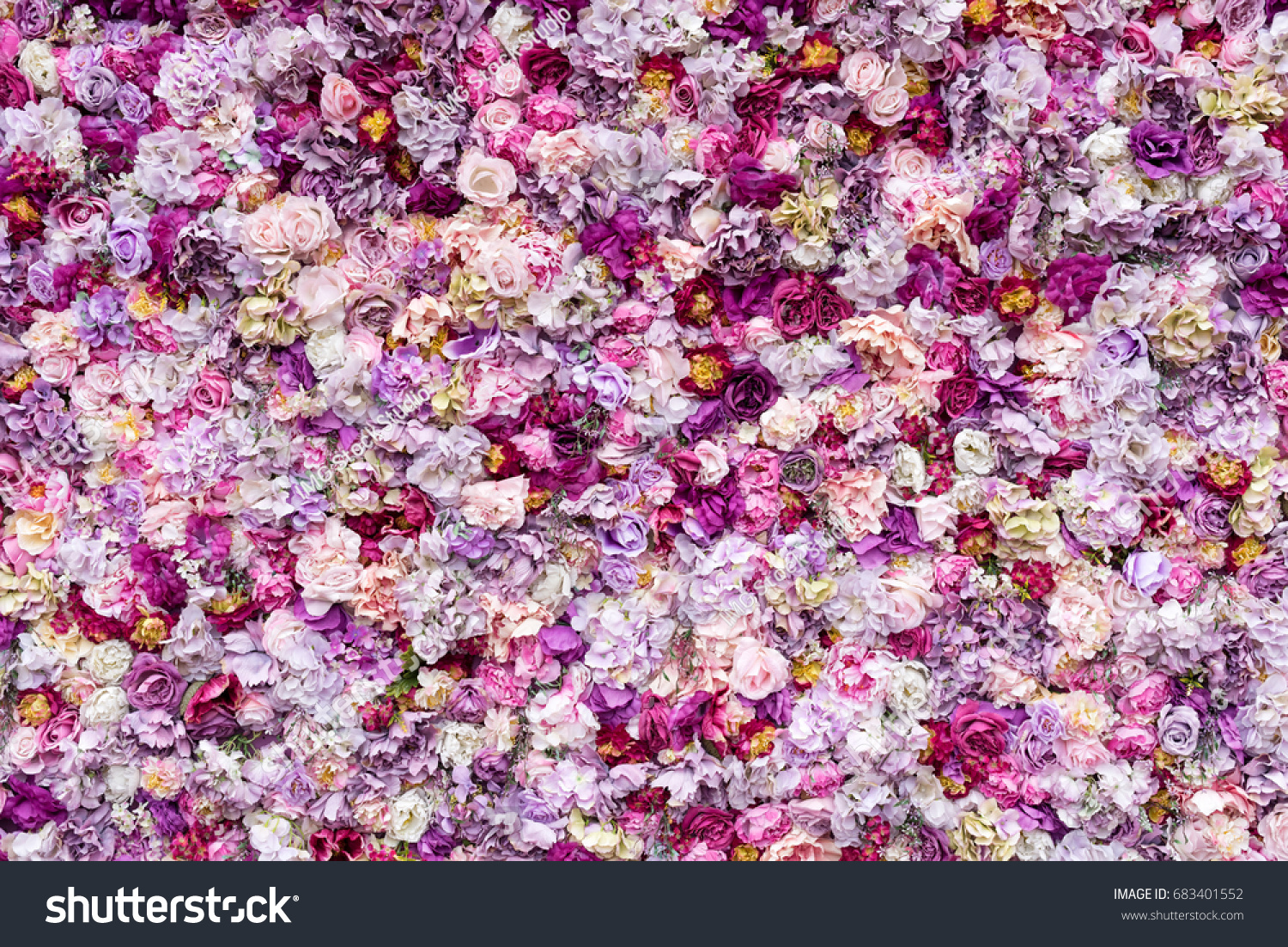 Flower texture background for wedding scene. Roses peonies and hydrangeas artificial flowers on the wall.