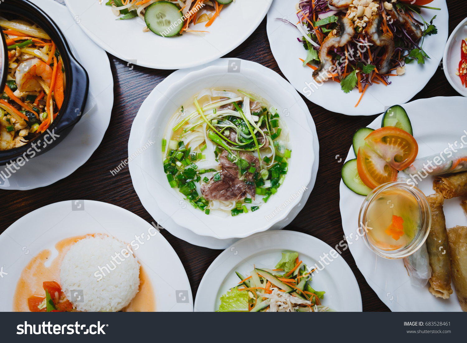 Exotic Vietnamese cuisine dinner in restaurant.Pho bo soup with boiled spicy beef meat seafood salad& fresh vegetables on table.Delicious Chinese food menu in cafe.Asian gourmet lunch top view